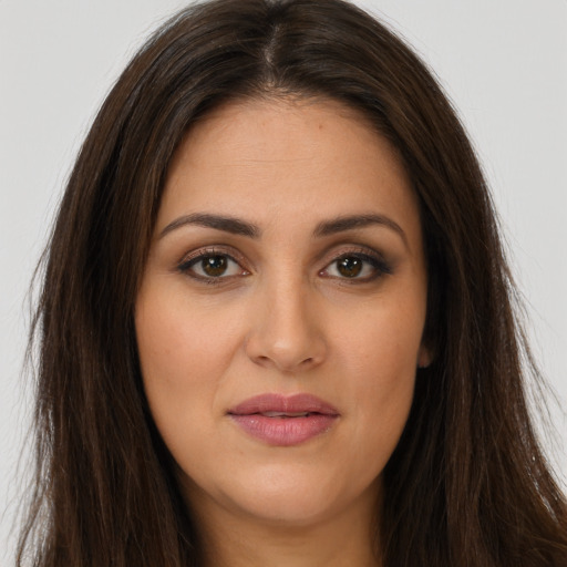 Joyful white young-adult female with long  brown hair and brown eyes
