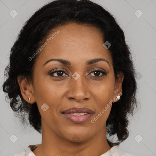 Joyful black adult female with medium  brown hair and brown eyes