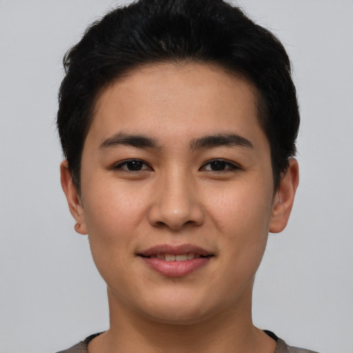 Joyful asian young-adult male with short  brown hair and brown eyes