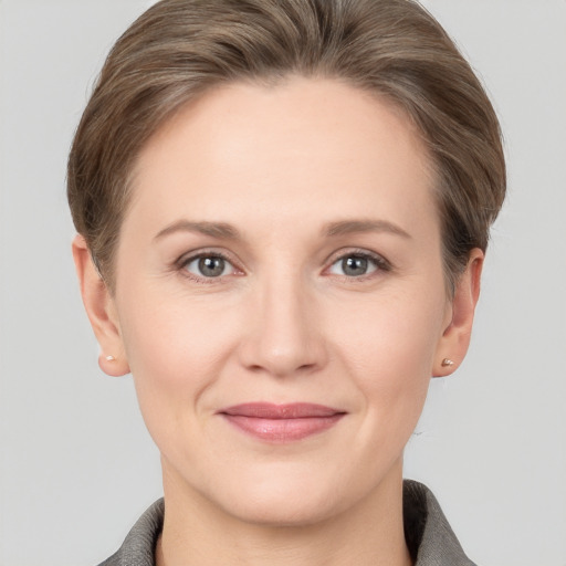 Joyful white young-adult female with short  brown hair and grey eyes