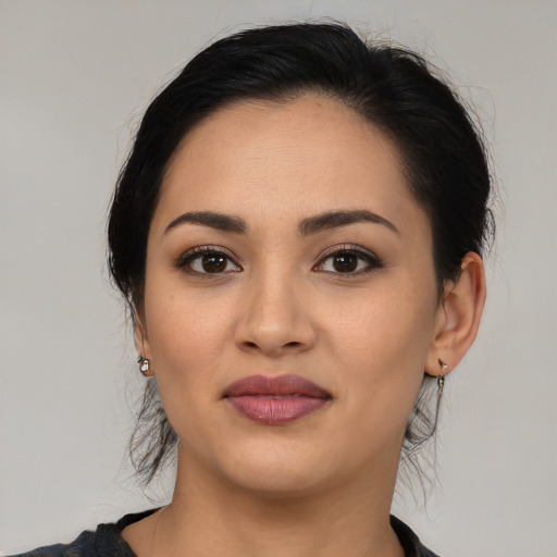 Joyful latino young-adult female with medium  black hair and brown eyes