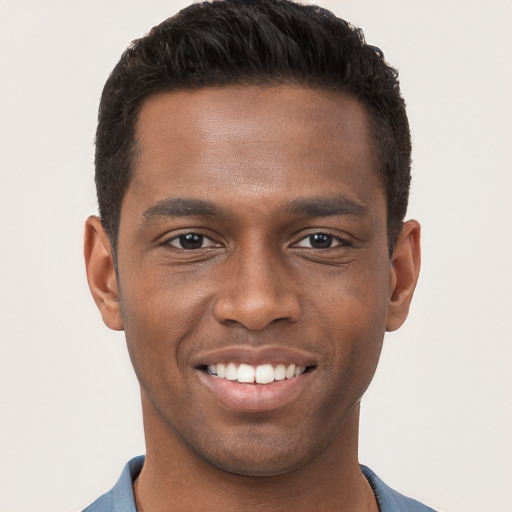 Joyful black young-adult male with short  brown hair and brown eyes