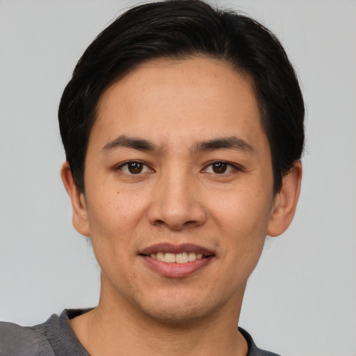 Joyful white young-adult male with short  black hair and brown eyes