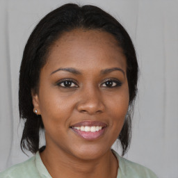 Joyful black young-adult female with medium  brown hair and brown eyes