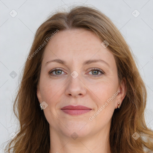 Joyful white adult female with long  brown hair and grey eyes