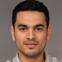 Joyful latino young-adult male with short  black hair and brown eyes