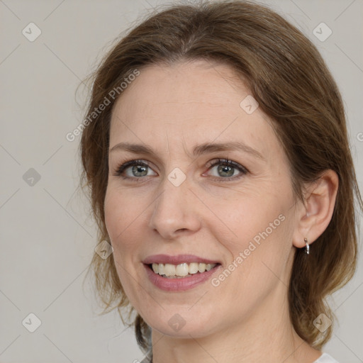 Joyful white adult female with medium  brown hair and grey eyes