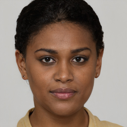 Joyful black young-adult female with short  brown hair and brown eyes