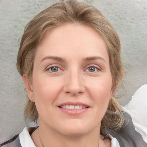 Joyful white young-adult female with medium  brown hair and blue eyes