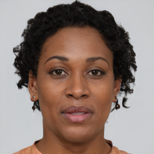 Joyful black adult female with short  brown hair and brown eyes