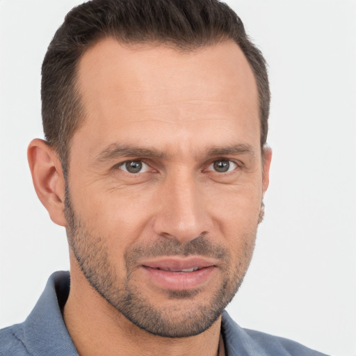 Joyful white adult male with short  brown hair and brown eyes