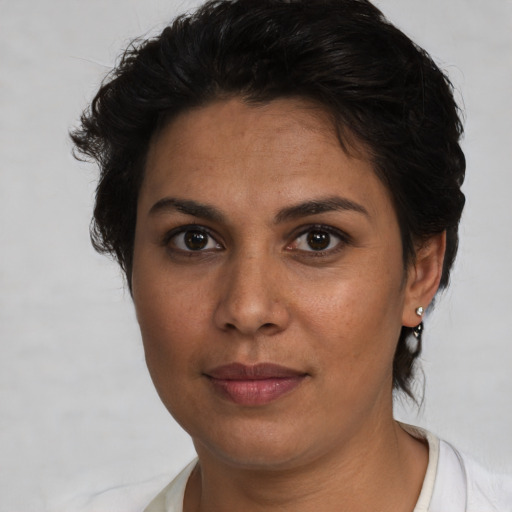 Joyful latino young-adult female with short  brown hair and brown eyes