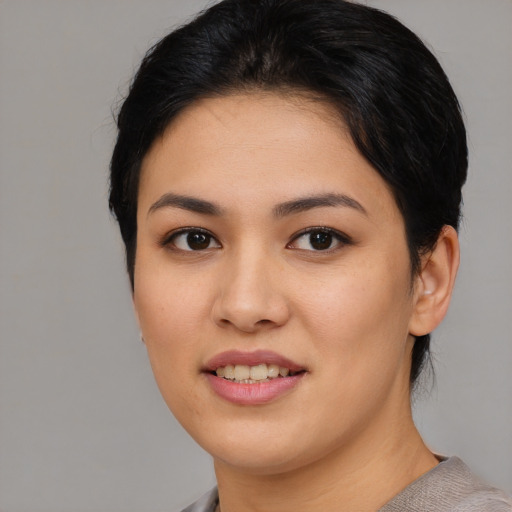 Joyful asian young-adult female with short  black hair and brown eyes