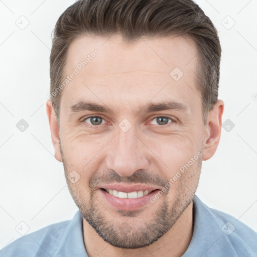 Joyful white adult male with short  brown hair and brown eyes