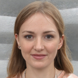 Joyful white young-adult female with medium  brown hair and grey eyes