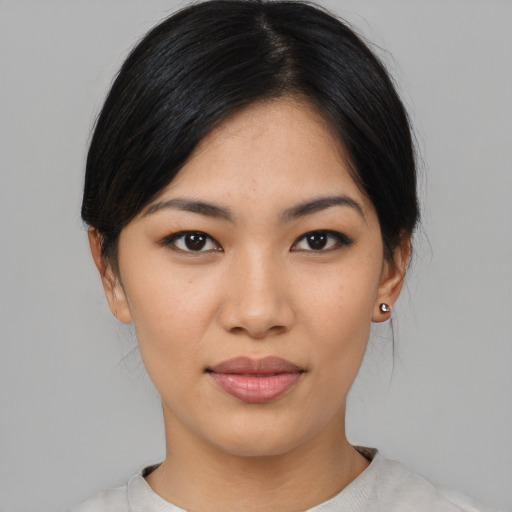 Joyful asian young-adult female with medium  black hair and brown eyes