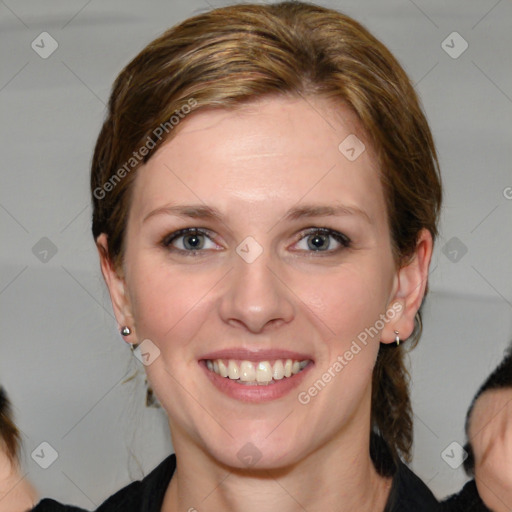 Joyful white young-adult female with medium  brown hair and blue eyes