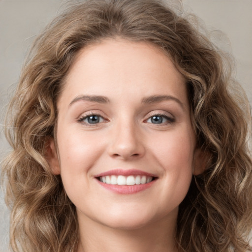 Joyful white young-adult female with medium  brown hair and green eyes