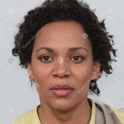 Joyful black adult female with short  brown hair and brown eyes