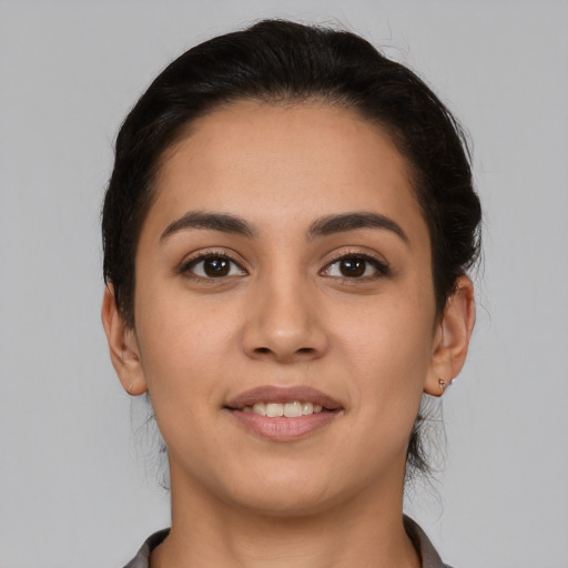 Joyful latino young-adult female with short  brown hair and brown eyes