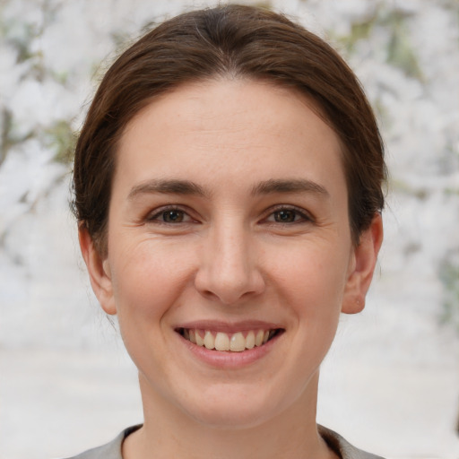 Joyful white young-adult female with short  brown hair and brown eyes