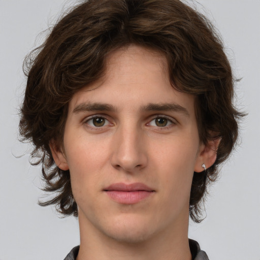 Joyful white young-adult male with medium  brown hair and brown eyes