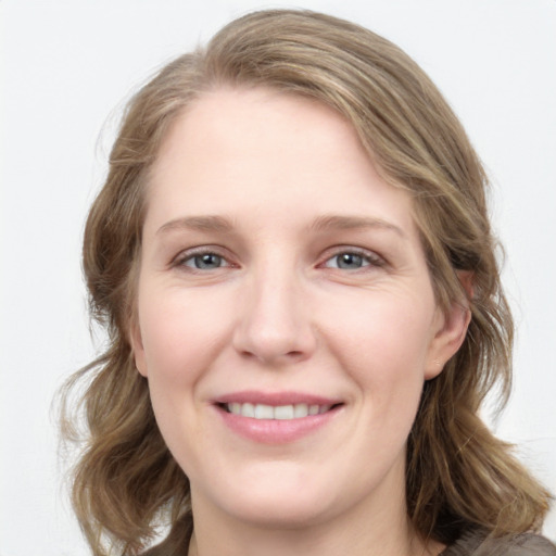 Joyful white young-adult female with medium  brown hair and blue eyes