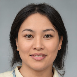 Joyful latino young-adult female with medium  brown hair and brown eyes