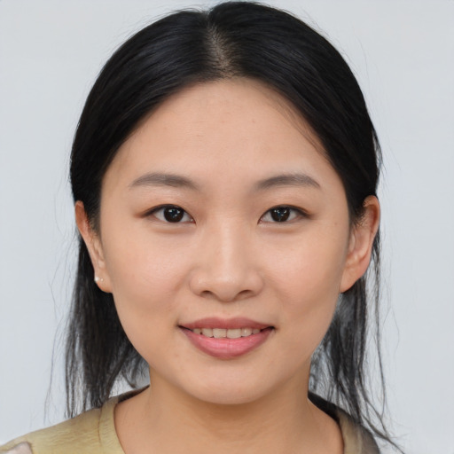 Joyful asian young-adult female with medium  brown hair and brown eyes