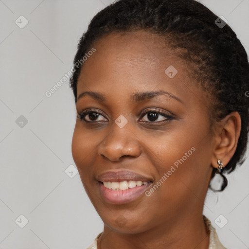 Joyful black young-adult female with short  brown hair and brown eyes