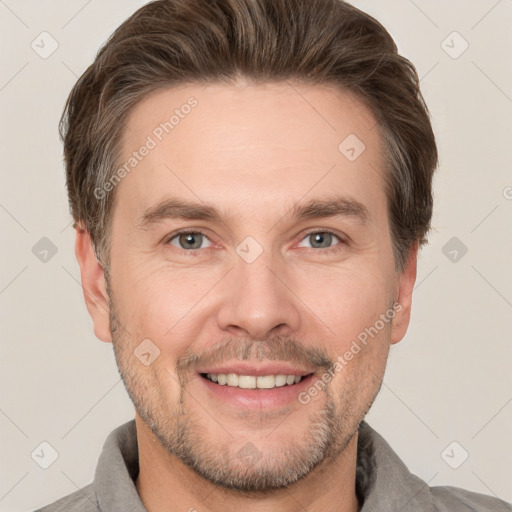 Joyful white adult male with short  brown hair and grey eyes