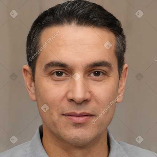 Joyful white adult male with short  black hair and brown eyes