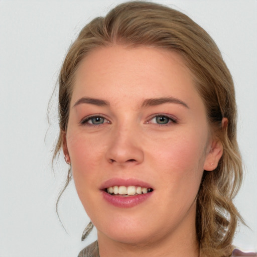 Joyful white young-adult female with medium  brown hair and blue eyes