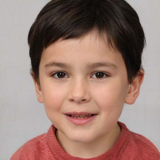 Joyful white child male with short  brown hair and brown eyes