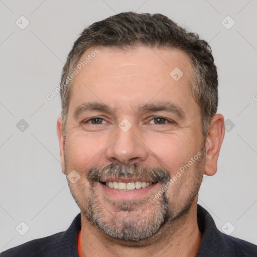 Joyful white adult male with short  brown hair and brown eyes