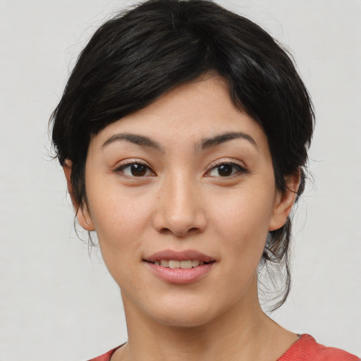 Joyful white young-adult female with medium  black hair and brown eyes