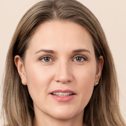 Joyful white young-adult female with long  brown hair and grey eyes