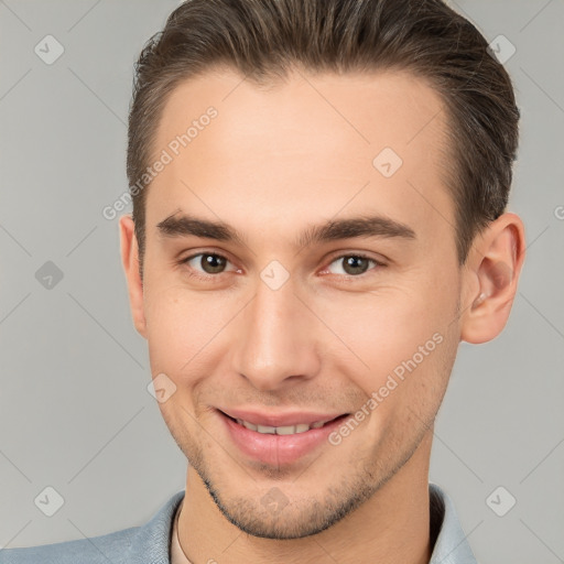 Joyful white young-adult male with short  brown hair and brown eyes