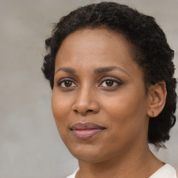 Joyful black adult female with medium  brown hair and brown eyes