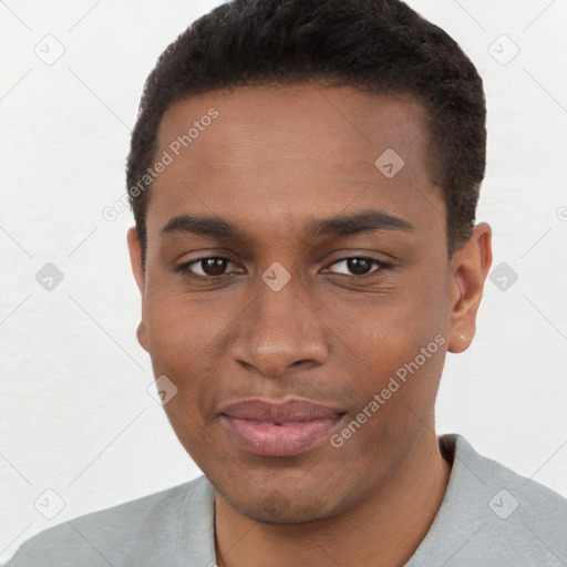 Joyful black young-adult male with short  brown hair and brown eyes