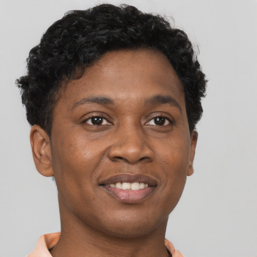 Joyful black young-adult female with short  brown hair and brown eyes