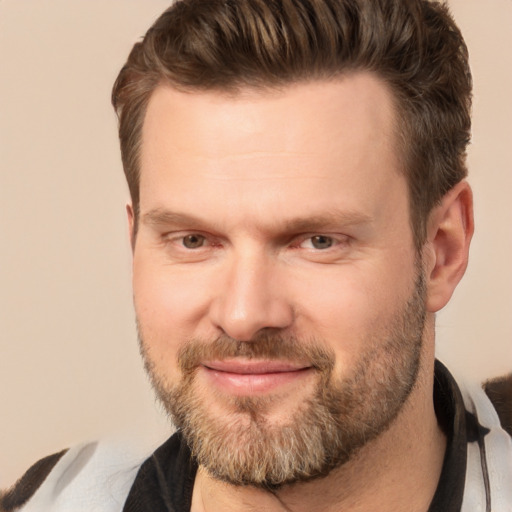 Joyful white adult male with short  brown hair and brown eyes