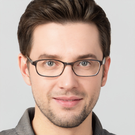 Joyful white young-adult male with short  brown hair and grey eyes