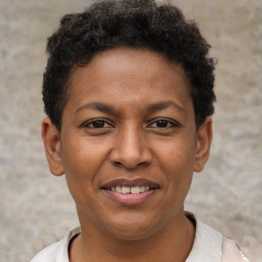 Joyful black young-adult female with short  brown hair and brown eyes