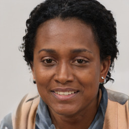 Joyful black adult female with short  brown hair and brown eyes