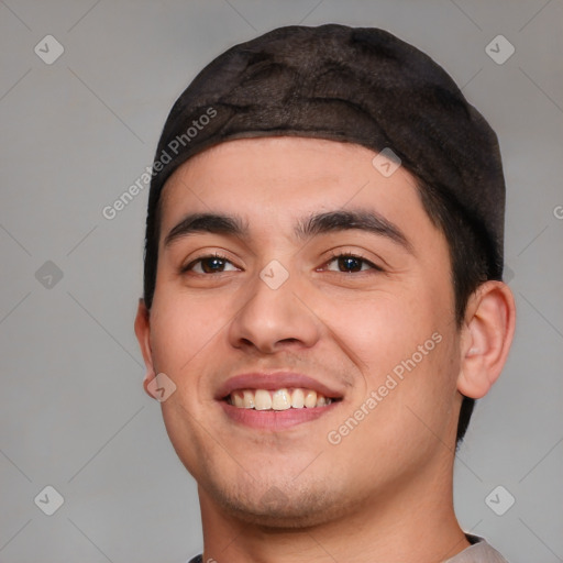 Joyful white young-adult male with short  black hair and brown eyes