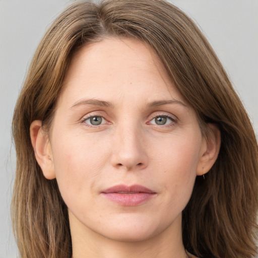 Joyful white adult female with long  brown hair and grey eyes