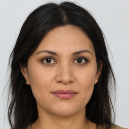 Joyful latino young-adult female with long  brown hair and brown eyes