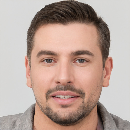 Joyful white young-adult male with short  brown hair and brown eyes