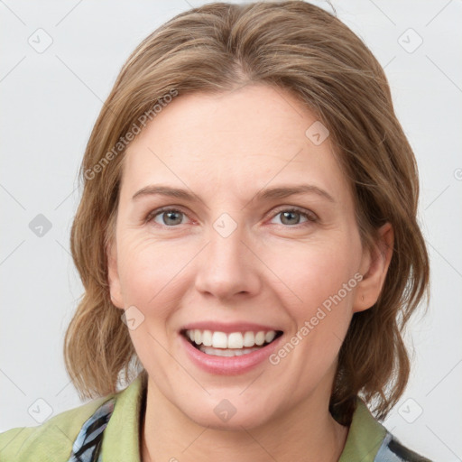 Joyful white young-adult female with medium  brown hair and blue eyes